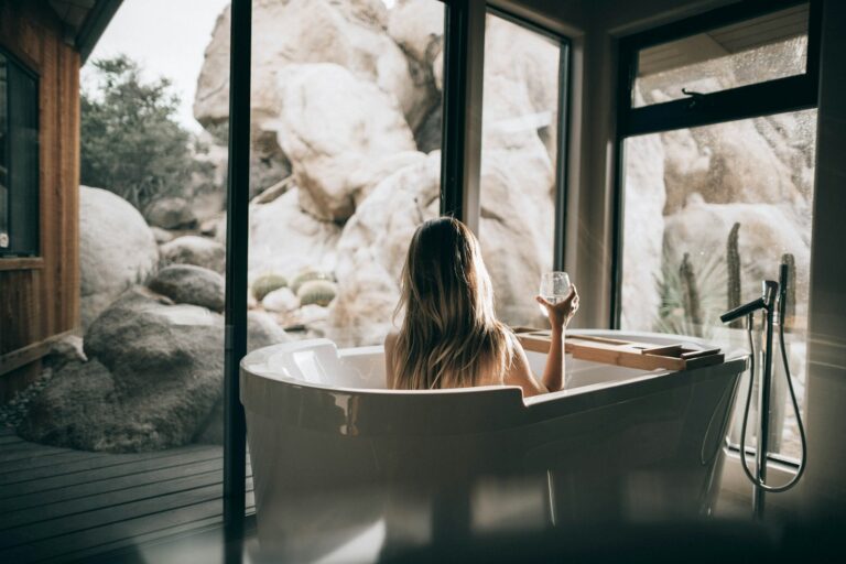 Home spa – domowa oaza relaksu, zdrowia i piękna woman in white bathtub holding clear drinking glass